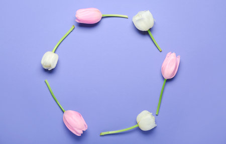 Frame made of beautiful tulip flowers on lilac background. mother's day celebrationの写真素材