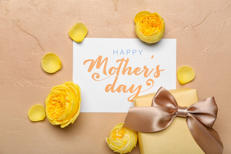Composition with gift box, greeting card and beautiful rose flowers on color background. mother's day celebrationの写真素材