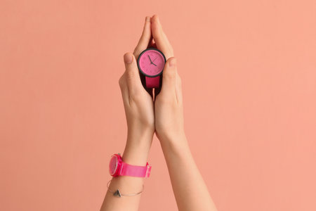 Woman with stylish wristwatches on pink backgroundの写真素材