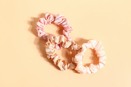 Stylish silk scrunchies on color backgroundの写真素材