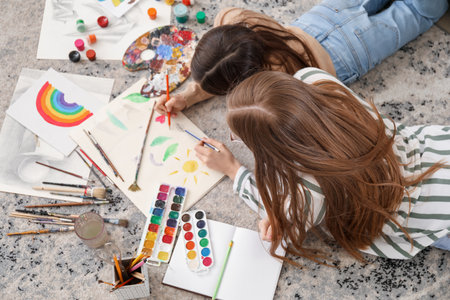 Drawing teacher giving private art lesson to little girl at home, top viewの写真素材