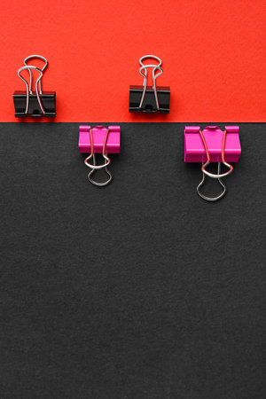 Binder clips on color backgroundの写真素材