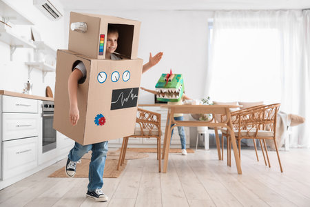 Little boy in cardboard robot costume playing at homeの写真素材