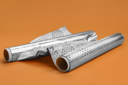 Rolls of aluminum foil on color backgroundの写真素材