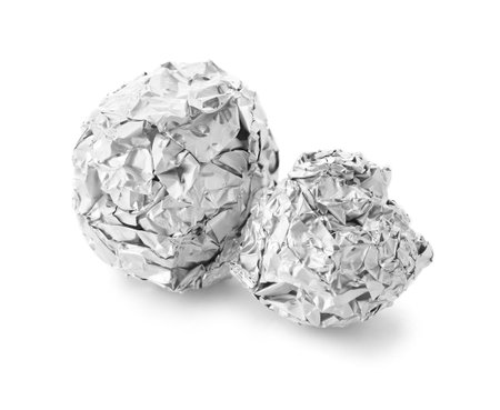 Crumpled balls of aluminum foil on white backgroundの写真素材