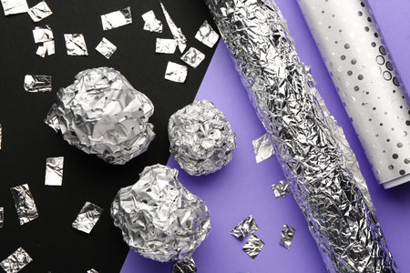 Composition with crumpled balls of aluminum foil on dark background