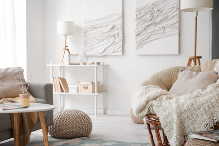 Interior of modern living room with sofa, armchair and creative artworkの写真素材