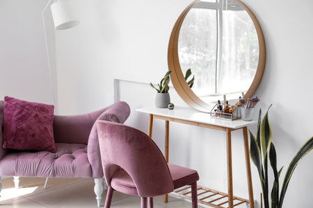 Interior of light makeup room with table, mirror and chairsの写真素材
