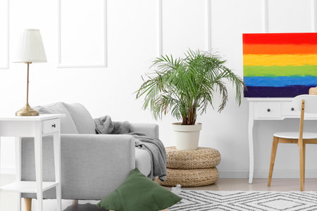 Interior of light living room with rainbow painting and tableの写真素材