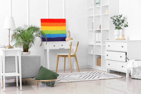 Interior of light living room with rainbow painting and tableの写真素材