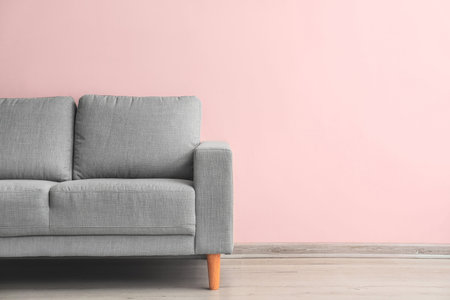 Stylish sofa near light wall in roomの写真素材