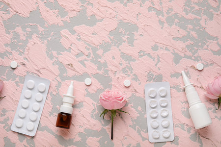 Nasal drops with pills and flowers on grunge background. Seasonal allergy concept