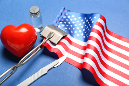 Surgical tools with heart and USA flag on blue background, closeupの写真素材