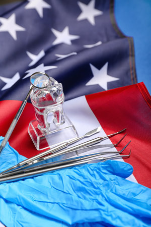 Dental tools with gloves and USA flag on blue background, closeupの写真素材