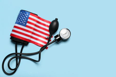USA flag with sphygmomanometer on blue backgroundの写真素材