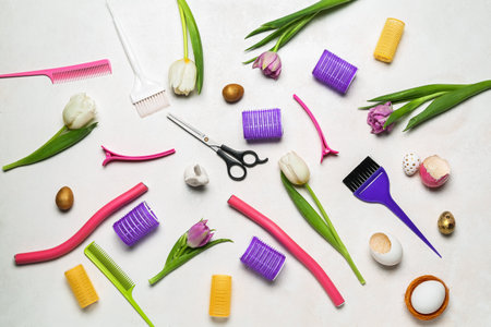 Hairdresser's tools with Easter eggs and tulips on white backgroundの写真素材