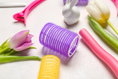 Curlers with Easter rabbit and tulips on white background, closeupの写真素材