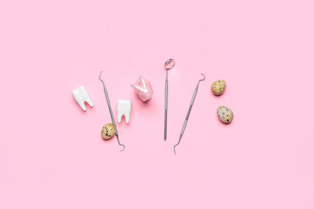 Dental tools with plastic teeth, Easter rabbit and eggs on pink background