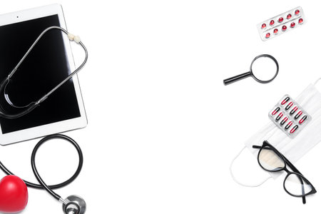 Frame made of tablet computer, stethoscope, pills, magnifier and eyeglasses on white background. world health dayの写真素材