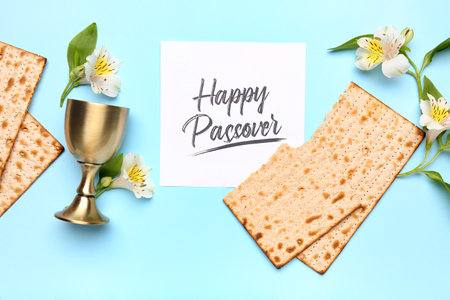 Composition with Jewish flatbread matza for Passover, card, cup and flowers on color backgroundの写真素材