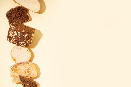 Slices of different bread on yellow backgroundの写真素材