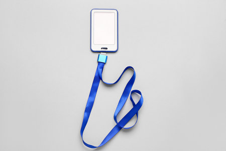 Blank badge with blue lanyard on light backgroundの写真素材