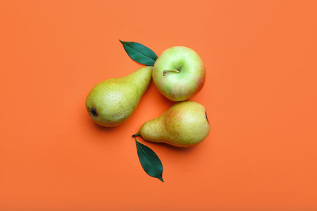fresh pear and apple on color background