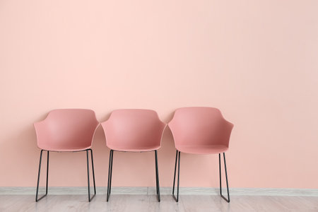 modern chairs near color wallの写真素材