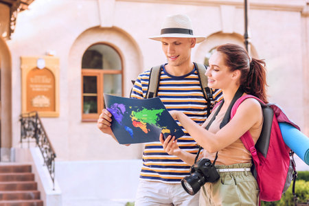 Couple of tourists with map on city streetの写真素材