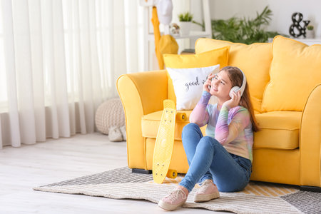 Teenage girl listening to music at homeの写真素材