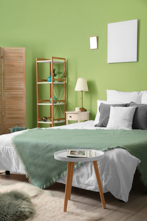 Stylish interior of bedroom with comfortable bedの写真素材