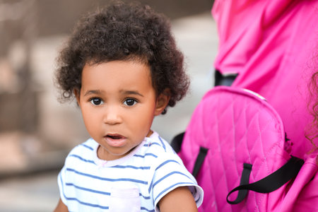 Cute African-American baby in stroller outdoorsの写真素材
