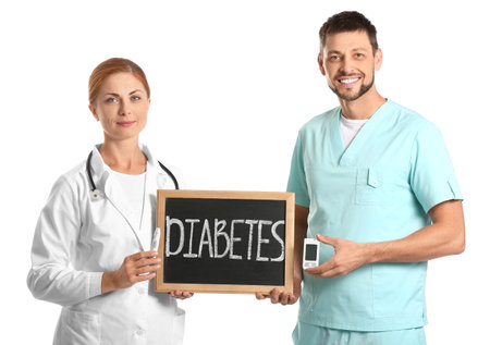 Doctors with digital glucometer and lancet pen on white background. Diabetes conceptの写真素材