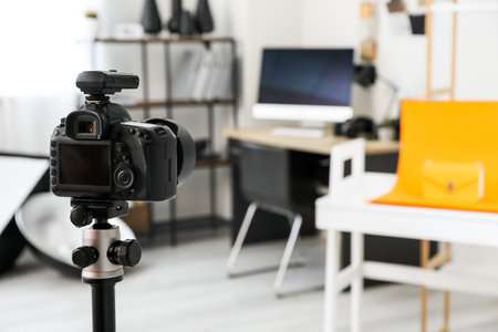 Professional camera on tripod in modern photo studioの写真素材