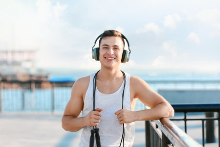 Sporty young man with headphones outdoorsの写真素材