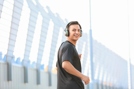 Sporty young man listening to music outdoorsの写真素材