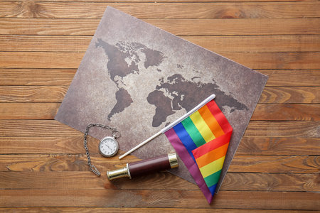 Rainbow LGBT flag and world map on wooden backgroundの写真素材