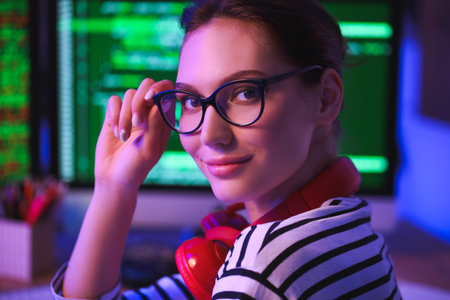 Female programmer working in office at nightの写真素材