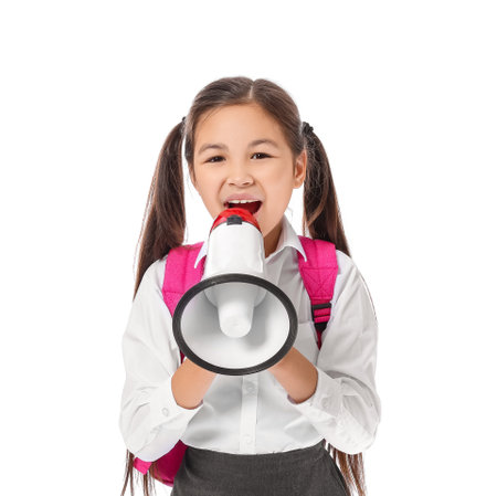 Little schoolgirl with megaphone on white backgroundの写真素材