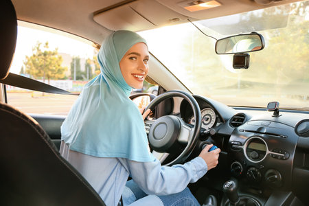 Young Muslim woman in modern carの写真素材
