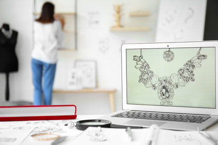 Workplace of jewelry designer with laptop in officeの写真素材