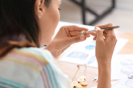 Female jewelry designer working in office, closeupの写真素材