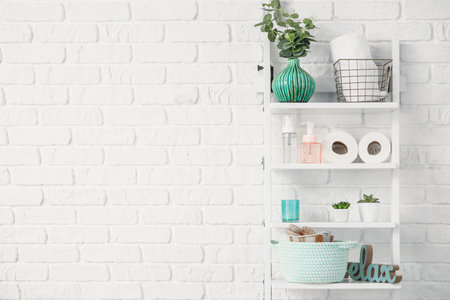 Rack with body care cosmetics and accessories in bathroomの写真素材