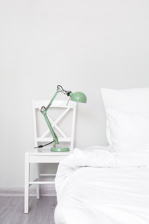 Chair with lamp in interior of comfortable room