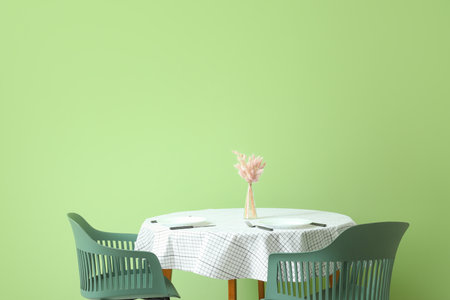 Table and chairs near color wallの写真素材