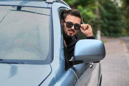 Handsome man in modern carの写真素材