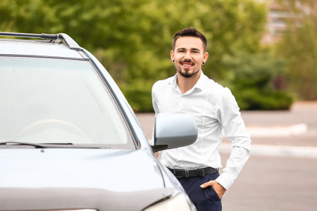 Handsome man near modern carの写真素材