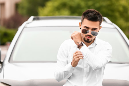 Handsome man near modern carの写真素材