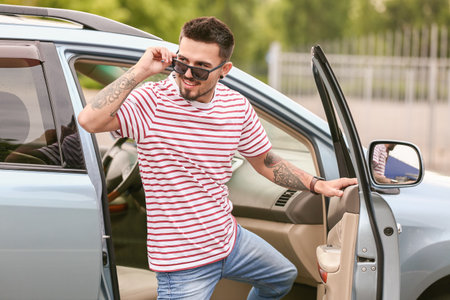 Handsome man near modern car
