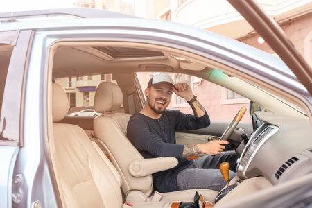 Handsome man in modern car